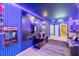 Spacious game room equipped with arcade games, mood lighting, and a wall-mounted television at 3926 Lana Ave, Davenport, FL 33897