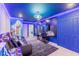 Spacious entertainment room with mood lighting, large wall decor, and arcade games at 3926 Lana Ave, Davenport, FL 33897