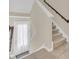 Bright entryway featuring a white front door, tiled floors, and staircase to the upper level at 486 Windmill Palm Cir, Altamonte Springs, FL 32701