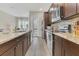 Modern kitchen with stainless steel appliances, backsplash, and granite countertops at 486 Windmill Palm Cir, Altamonte Springs, FL 32701