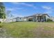 Spacious backyard with green grass, white fence, gazebo, shed, and patio area at 4860 Osprey Way, Winter Haven, FL 33881