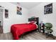 Cozy bedroom featuring wood floors, black furniture, and brightly colored decor at 4860 Osprey Way, Winter Haven, FL 33881