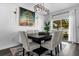 Dining area with a modern chandelier, large art piece and a view of the screened-in porch at 4860 Osprey Way, Winter Haven, FL 33881