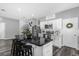 Bright kitchen with white cabinets, an island with seating, and modern stainless steel appliances at 4860 Osprey Way, Winter Haven, FL 33881