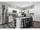 Well-lit kitchen featuring white cabinetry, stainless steel appliances, and a functional island with seating at 4860 Osprey Way, Winter Haven, FL 33881