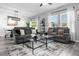 Bright living room featuring comfortable gray seating, stylish decor, and ample natural light at 4860 Osprey Way, Winter Haven, FL 33881