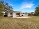 Expansive backyard featuring a lush lawn and a well-maintained exterior of the home at 5404 Milan Dr, Orlando, FL 32810