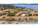 Aerial view of condo complex with a community pool, landscaping and lake views at 5405 Hansel Ave # G9, Orlando, FL 32809