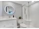 Modern bathroom featuring vanity with round LED mirror and a glass-enclosed shower at 5405 Hansel Ave # G9, Orlando, FL 32809