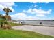 Lakefront beach area for residents with sandy shore and boat access under a partly cloudy blue sky at 5405 Hansel Ave # G9, Orlando, FL 32809