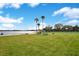 Expansive lawn area near the lake with picnic tables, a grill, and tennis and basketball courts at 5405 Hansel Ave # G9, Orlando, FL 32809