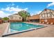 Community pool with blue lounge chairs and Tudor-style buildings in the background at 5405 Hansel Ave # G9, Orlando, FL 32809