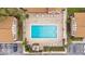 Aerial view of a sparkling pool with lounge chairs in the center of the community at 5405 Hansel Ave # G9, Orlando, FL 32809