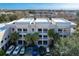 Aerial view of townhomes with balconies, parking, and mature trees at 580 Water St # F, Kissimmee, FL 34747