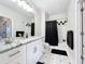 Clean bathroom featuring white cabinets, granite countertop, and a shower with a black curtain at 580 Water St # F, Kissimmee, FL 34747