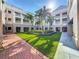 A beautiful courtyard features lush green grass and palm trees, creating a serene outdoor space at 580 Water St # F, Kissimmee, FL 34747