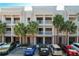 Townhome exterior view showcasing balconies, neutral paint, and parking spaces in front at 580 Water St # F, Kissimmee, FL 34747