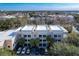 Exterior shot of the condo building, featuring balconies, palm trees and reserved parking at 580 Water St # F, Kissimmee, FL 34747