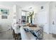 Stylish kitchen island with white chairs, granite countertop, modern lighting, and white cabinetry at 580 Water St # F, Kissimmee, FL 34747