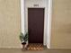 Inviting front door with decorative doormat and potted plant, unit number 303 at 583 Brantley Terrace Way # 303, Altamonte Springs, FL 32714