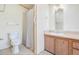 Bathroom featuring toilet, sink, vanity, shower with curtain, and tile floors at 6302 Bayberry Ne Blvd, Winter Haven, FL 33881