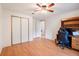 Bedroom with wood floors, closet, ceiling fan, and desk at 6302 Bayberry Ne Blvd, Winter Haven, FL 33881