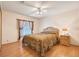 Comfortable bedroom with a floral bedspread, wood floors, and a window at 6302 Bayberry Ne Blvd, Winter Haven, FL 33881