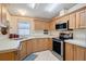 Well-lit kitchen featuring light wood cabinets, stainless steel appliances, and modern countertops at 6302 Bayberry Ne Blvd, Winter Haven, FL 33881