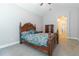 Bedroom with neutral walls, carpet, ceiling fan, and a decorative wood bed frame at 6825 Dolce St, Orlando, FL 32819