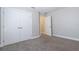 Bedroom with carpet flooring, closet doors, and a view to an additional room at 6825 Dolce St, Orlando, FL 32819