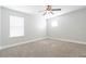 Bedroom features neutral carpet, ceiling fan, and window with blinds at 6825 Dolce St, Orlando, FL 32819