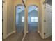 Hallway features mirrors and leads to bedrooms with vaulted ceilings and ceiling fans at 6825 Dolce St, Orlando, FL 32819