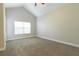 Bedroom with vaulted ceiling, ceiling fan, window, and neutral carpeting at 6825 Dolce St, Orlando, FL 32819