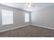 Well-lit bedroom with neutral walls, carpet, and window with white blinds at 6825 Dolce St, Orlando, FL 32819