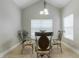Dining area featuring a glass table, chandelier lighting and neutral colored tile flooring at 6825 Dolce St, Orlando, FL 32819