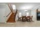 Dining room with wood staircase, and view of an elegant chandelier above a hardwood dining table at 6825 Dolce St, Orlando, FL 32819