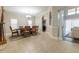 Open dining area with hardwood table, decorative chandelier, and view into the living room at 6825 Dolce St, Orlando, FL 32819
