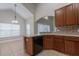 Kitchen featuring stainless steel appliances, wooden cabinets, and cozy eating area at 6825 Dolce St, Orlando, FL 32819