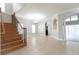 Bright living room featuring a staircase with hardwood steps and tile flooring at 6825 Dolce St, Orlando, FL 32819