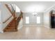 Bright living room with a staircase featuring hardwood steps and a chandelier at 6825 Dolce St, Orlando, FL 32819