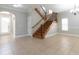 Spacious living room featuring tile flooring, a staircase with iron railings, and plenty of natural light at 6825 Dolce St, Orlando, FL 32819