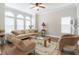 Bright living room with large windows, hardwood floors, neutral color palette, and stylish decor at 6825 Dolce St, Orlando, FL 32819