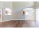 Light-filled living room featuring hardwood floors and arched entryways, creating an inviting atmosphere at 6825 Dolce St, Orlando, FL 32819