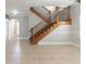 Spacious living room featuring tile flooring, a staircase with iron railings, and plenty of natural light at 6825 Dolce St, Orlando, FL 32819