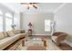 Bright living room with large windows, ceiling fan, hardwood floors, and a neutral color palette at 6825 Dolce St, Orlando, FL 32819