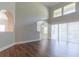 Bright living room with wood floors, arched doorways, and a high ceiling for a modern living space at 6825 Dolce St, Orlando, FL 32819