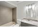 Bathroom featuring granite countertop, modern vanity, and a tiled shower/tub combo at 7250 Oak Meadows Cir, Orlando, FL 32835