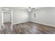 Spacious bedroom with wood-look flooring, a ceiling fan, and bright window at 7250 Oak Meadows Cir, Orlando, FL 32835