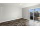 Neutral bedroom with wood-look flooring and sliding glass door access to outdoor space at 7250 Oak Meadows Cir, Orlando, FL 32835