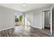 Bedroom featuring wood-look flooring, ample closet space, and a sliding door that leads to the backyard at 7250 Oak Meadows Cir, Orlando, FL 32835